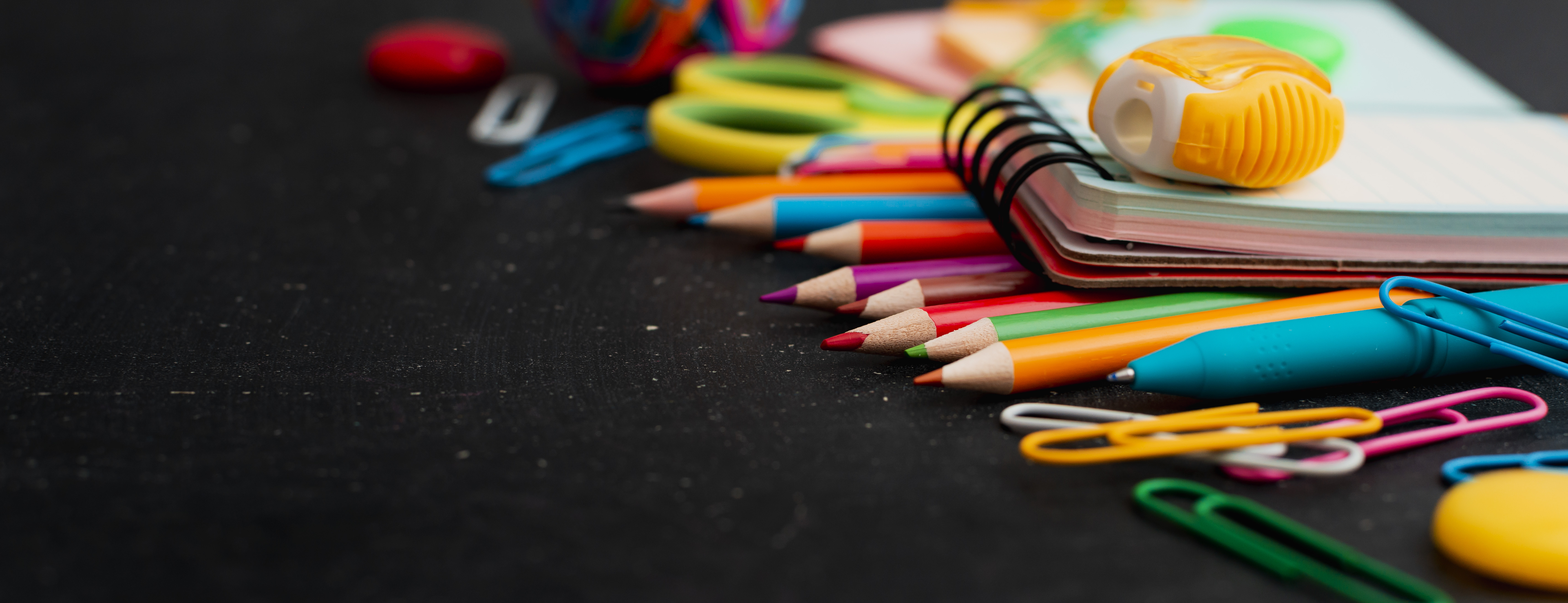 school supplies top view on the chalkboard